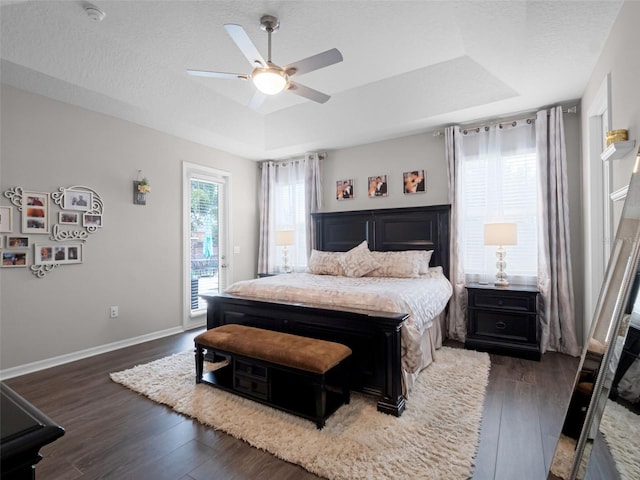 14903 Ellingsworth Ln, Winter Garden, FL 34787 - bedroom with access to outside, wood finished floors, a raised ceiling, and a ceiling fan