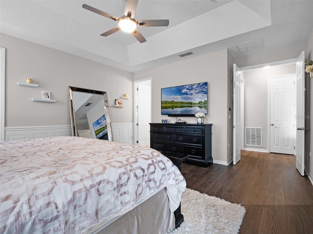14903 Ellingsworth Ln, Winter Garden, FL 34787 - bedroom with a tray ceiling, dark wood finished floors, and a ceiling fan