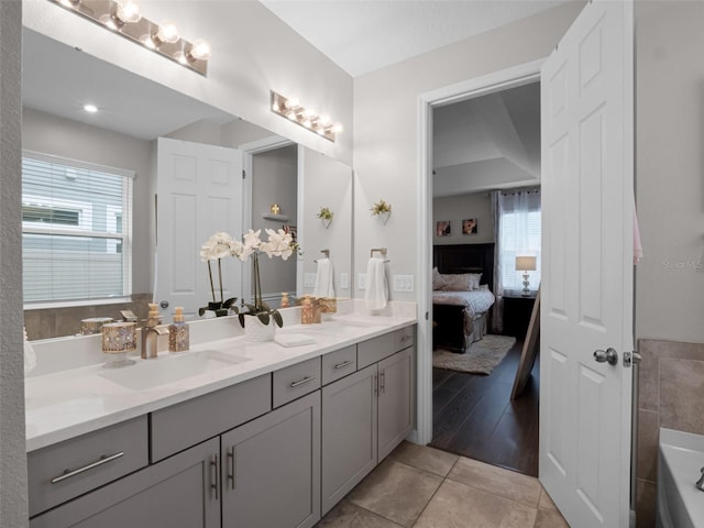 14903 Ellingsworth Ln, Winter Garden, FL 34787 - ensuite bathroom with double vanity, healthy amount of natural light, a bathtub, and tile patterned floors