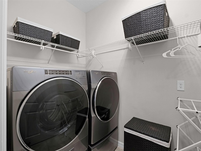 14903 Ellingsworth Ln, Winter Garden, FL 34787 - laundry room featuring washing machine and dryer and baseboards