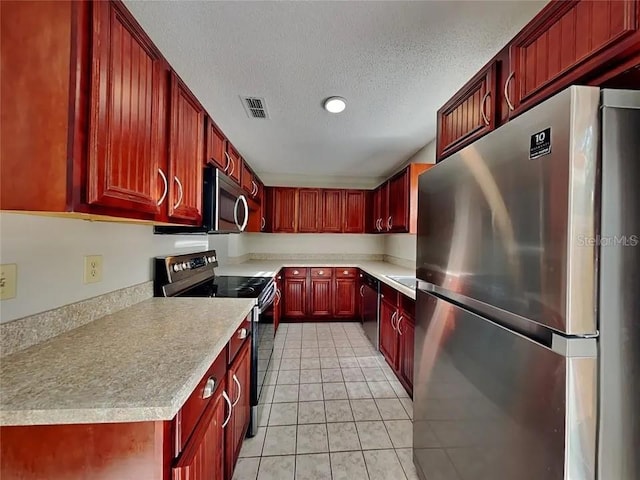 1709 Shady Ridge Ct Unit 243, Orlando, FL 32807 - kitchen with appliances with stainless steel finishes, dark brown cabinets, light countertops, a textured ceiling, and light tile patterned floors