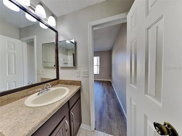 1709 Shady Ridge Ct Unit 243, Orlando, FL 32807 - bathroom with vanity, a textured ceiling, and wood finished floors