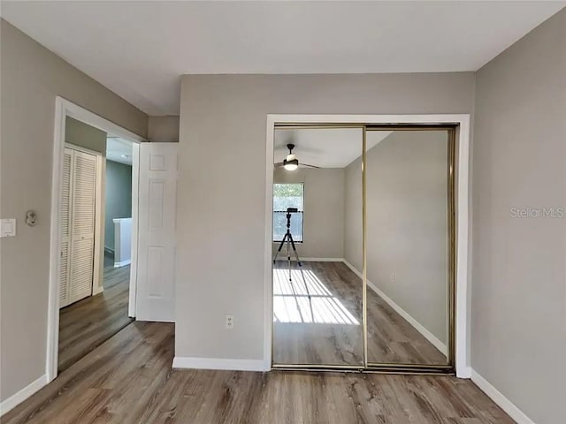 1709 Shady Ridge Ct Unit 243, Orlando, FL 32807 - unfurnished bedroom featuring wood finished floors and a closet