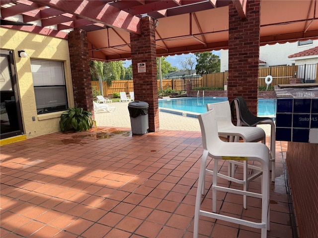 1709 Shady Ridge Ct Unit 243, Orlando, FL 32807 - fenced backyard with a community pool, a patio, and a pergola