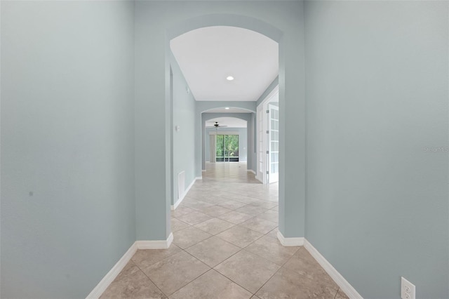 7540 Bishop Square Dr, Winter Garden, FL 34787 - hallway with arched walkways, light tile patterned floors, and recessed lighting