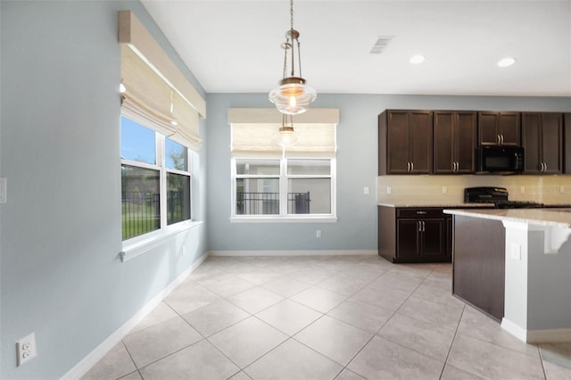7540 Bishop Square Dr, Winter Garden, FL 34787 - kitchen featuring black microwave, dark brown cabinets, decorative light fixtures, light countertops, and range