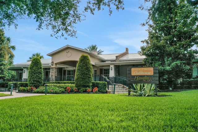 7540 Bishop Square Dr, Winter Garden, FL 34787 - view of front facade with stucco siding, a front lawn, stone siding, and a porch