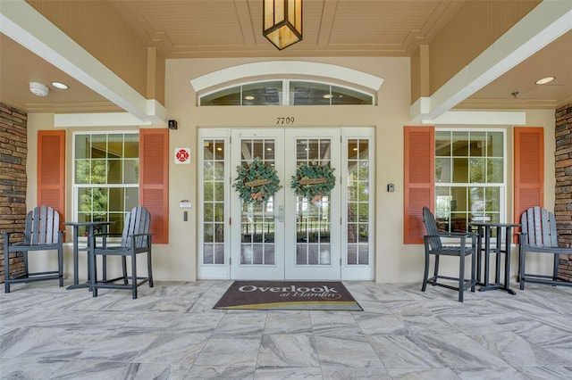7540 Bishop Square Dr, Winter Garden, FL 34787 - property entrance featuring french doors, a porch, and stucco siding