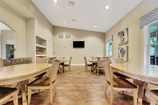 7540 Bishop Square Dr, Winter Garden, FL 34787 - dining space with plenty of natural light, light wood-style flooring, arched walkways, vaulted ceiling, and recessed lighting