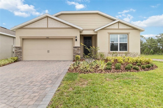 17461 Back Bay Ct, Clermont, FL 34714 - view of front facade with decorative driveway, stone siding, an attached garage, a front lawn, and stucco siding