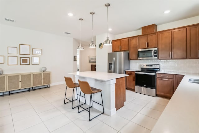 17461 Back Bay Ct, Clermont, FL 34714 - kitchen with stainless steel appliances, a kitchen breakfast bar, decorative backsplash, a kitchen island, and light countertops