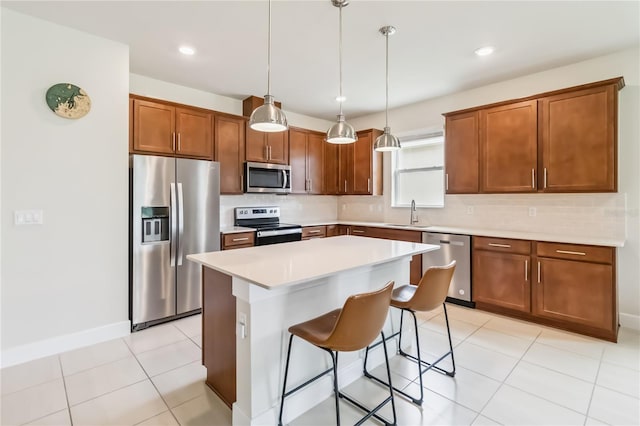 17461 Back Bay Ct, Clermont, FL 34714 - kitchen featuring stainless steel appliances, backsplash, a kitchen breakfast bar, light countertops, and a kitchen island