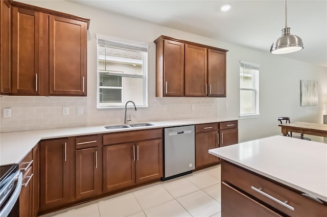 17461 Back Bay Ct, Clermont, FL 34714 - kitchen featuring stainless steel dishwasher, decorative backsplash, light countertops, range, and hanging light fixtures