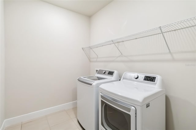 17461 Back Bay Ct, Clermont, FL 34714 - washroom with separate washer and dryer and light tile patterned flooring