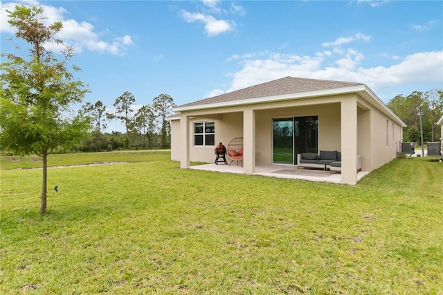 17461 Back Bay Ct, Clermont, FL 34714 - rear view of property with a patio, stucco siding, outdoor lounge area, and a yard