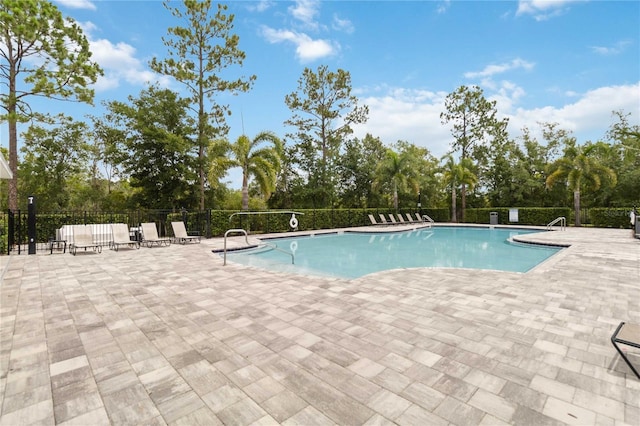 17461 Back Bay Ct, Clermont, FL 34714 - community pool with view of wooded area and a patio area