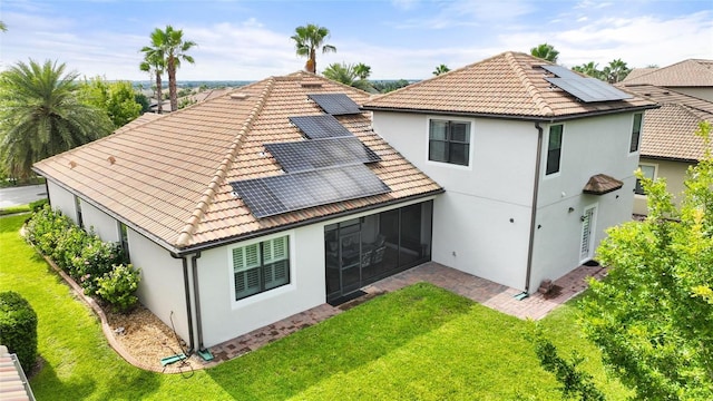 1406 Deuce Cir, Champions Gate, FL 33896 - back of property with roof mounted solar panels, stucco siding, and a yard
