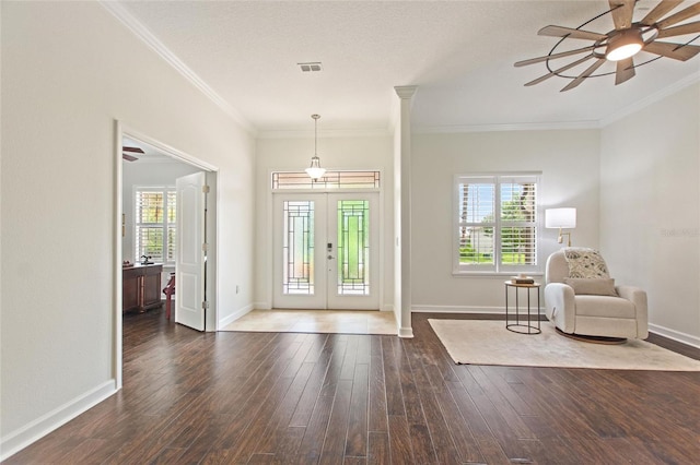 1406 Deuce Cir, Champions Gate, FL 33896 - foyer entrance featuring crown molding, ceiling fan, plenty of natural light, wood finished floors, and french doors