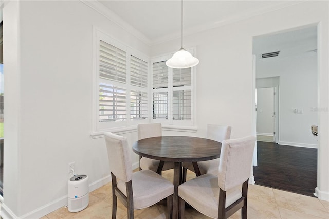 1406 Deuce Cir, Champions Gate, FL 33896 - dining space with ornamental molding and light tile patterned flooring