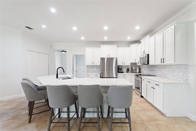 1406 Deuce Cir, Champions Gate, FL 33896 - kitchen featuring stainless steel appliances, a large island, tasteful backsplash, a kitchen breakfast bar, and crown molding