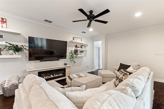 1406 Deuce Cir, Champions Gate, FL 33896 - living room with dark wood-style floors, ceiling fan, ornamental molding, recessed lighting, and a glass covered fireplace