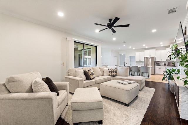 1406 Deuce Cir, Champions Gate, FL 33896 - living area featuring ceiling fan, recessed lighting, dark wood-style flooring, and crown molding