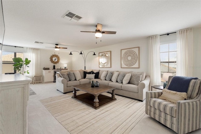 1406 Deuce Cir, Champions Gate, FL 33896 - living room with healthy amount of natural light, a ceiling fan, light colored carpet, and wine cooler