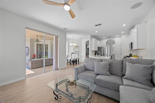 11222 Rapallo Ln, Windermere, FL 34786 - living area with a ceiling fan, arched walkways, plenty of natural light, light wood-type flooring, and recessed lighting