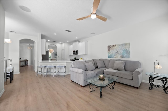 11222 Rapallo Ln, Windermere, FL 34786 - living area with light wood-style floors, ceiling fan, arched walkways, a chandelier, and recessed lighting