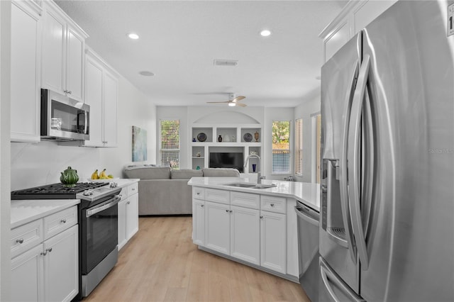 11222 Rapallo Ln, Windermere, FL 34786 - kitchen with stainless steel appliances, a peninsula, plenty of natural light, light countertops, and recessed lighting