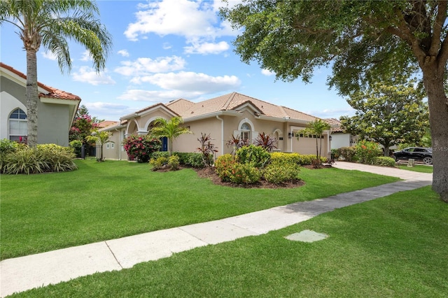11222 Rapallo Ln, Windermere, FL 34786 - mediterranean / spanish-style house with driveway, an attached garage, a front lawn, stucco siding, and a tiled roof