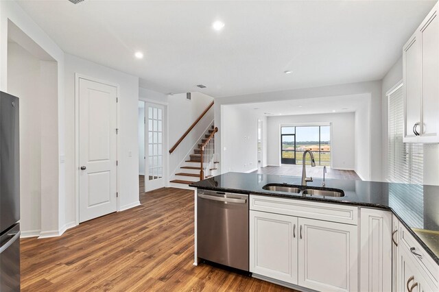 2604 Pinnacle, Clermont, FL 34711 - kitchen featuring appliances with stainless steel finishes, white cabinets, a peninsula, light wood finished floors, and recessed lighting