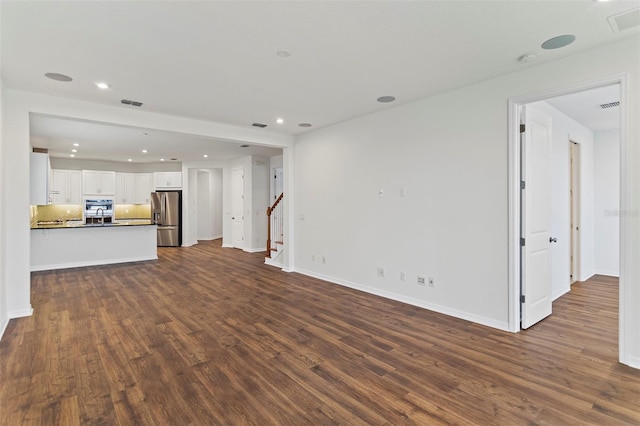 2604 Pinnacle, Clermont, FL 34711 - unfurnished living room with dark wood-type flooring, recessed lighting, and stairway