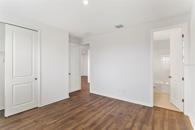 2604 Pinnacle, Clermont, FL 34711 - unfurnished bedroom with dark wood-style floors, a closet, and ensuite bathroom