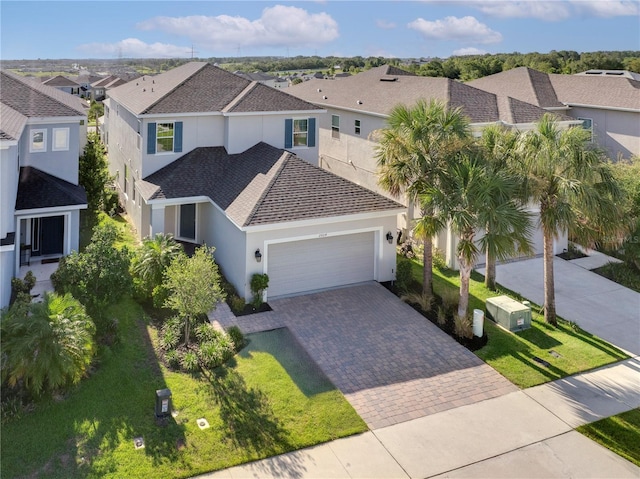 2604 Pinnacle, Clermont, FL 34711 - view of front facade with a residential view, stucco siding, an attached garage, decorative driveway, and roof with shingles