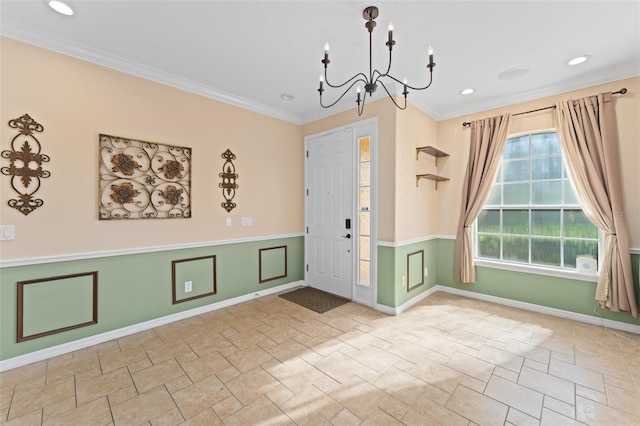 1011 Wood Cv, Kissimmee, FL 34743 - entrance foyer featuring stone tile floors, crown molding, a chandelier, wainscoting, and recessed lighting