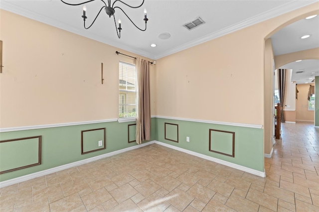 1011 Wood Cv, Kissimmee, FL 34743 - empty room featuring arched walkways, ornamental molding, stone finish flooring, a chandelier, and wainscoting