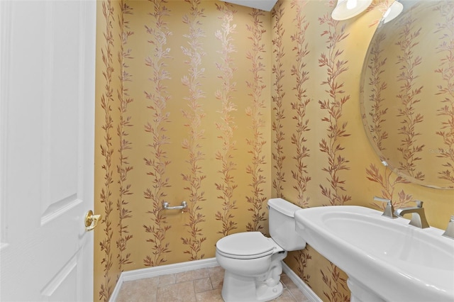 1011 Wood Cv, Kissimmee, FL 34743 - bathroom featuring baseboards and a sink