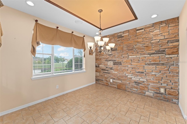 1011 Wood Cv, Kissimmee, FL 34743 - spare room with a chandelier, stone finish flooring, and recessed lighting