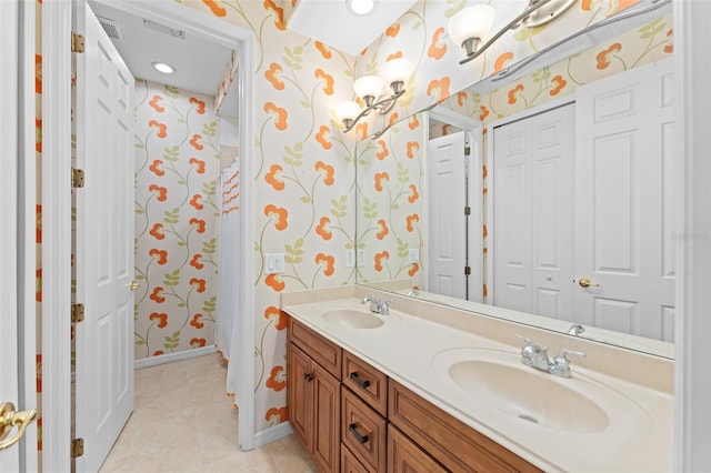1011 Wood Cv, Kissimmee, FL 34743 - full bath with wallpapered walls, double vanity, a closet, and tile patterned flooring