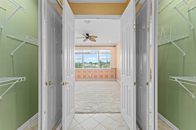 1011 Wood Cv, Kissimmee, FL 34743 - spacious closet featuring light carpet, light tile patterned floors, and a ceiling fan
