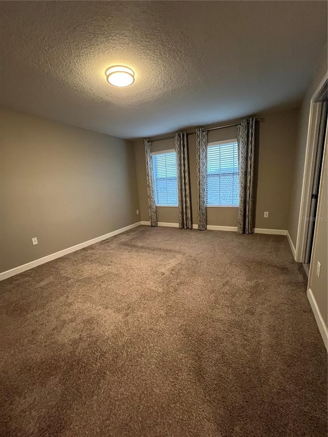 8512 Player Point Dr, Davenport, FL 33896 - spare room featuring a textured ceiling and carpet flooring