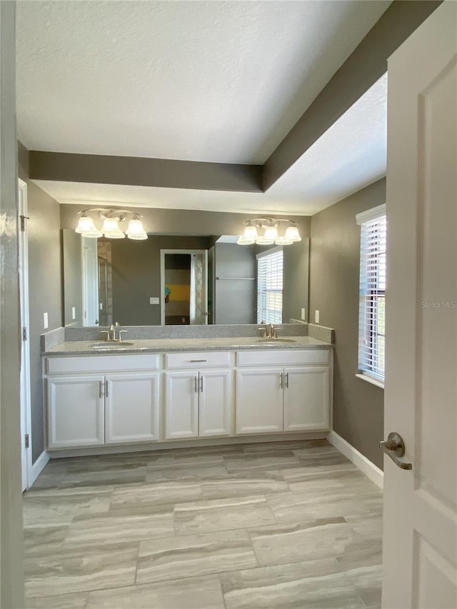 8512 Player Point Dr, Davenport, FL 33896 - bathroom featuring double vanity and a textured ceiling