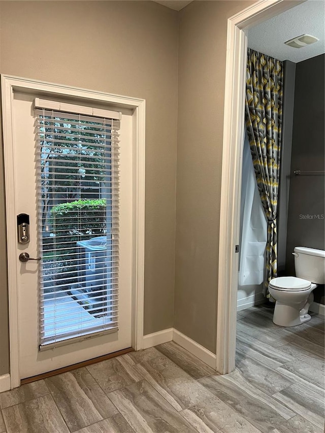 8512 Player Point Dr, Davenport, FL 33896 - bathroom view of wood finished floors and toilet