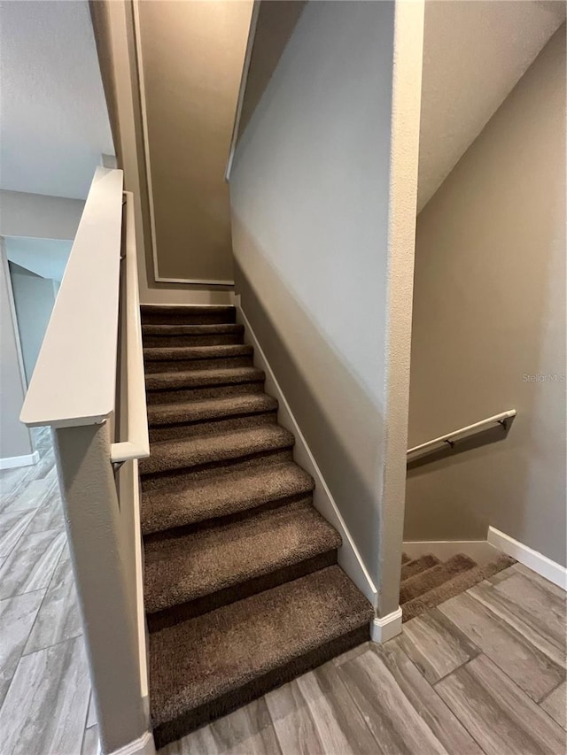 8512 Player Point Dr, Davenport, FL 33896 - stairs featuring baseboards and wood finished floors
