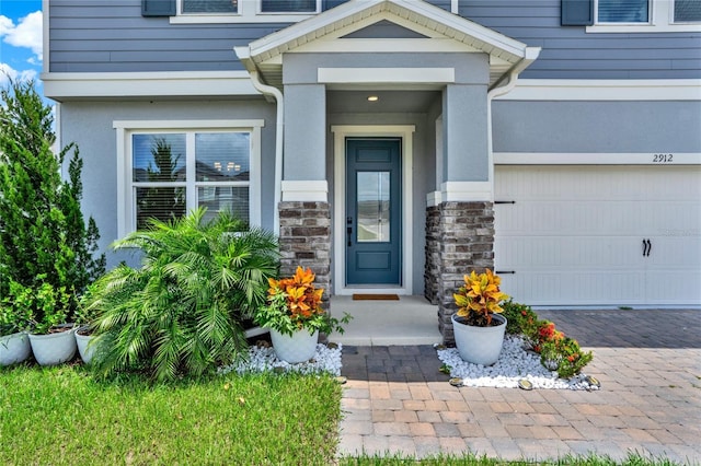 2912 Sanctuary Dr, Clermont, FL 34714 - property entrance featuring stone siding, a garage, and driveway