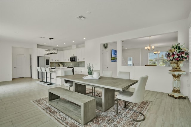 2912 Sanctuary Dr, Clermont, FL 34714 - dining area featuring a chandelier, light wood-style flooring, and recessed lighting