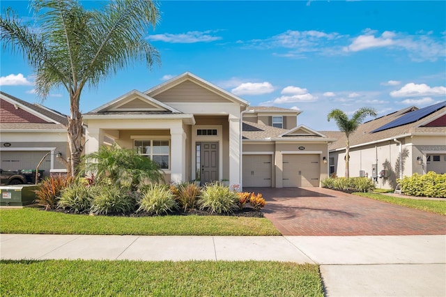 1564 Atlantic Coastline Loop, Oakland, FL 34787 - view of front of house featuring decorative driveway, a garage, and stucco siding
