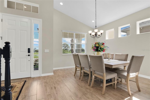 1564 Atlantic Coastline Loop, Oakland, FL 34787 - dining room with a chandelier, light wood-style flooring, high vaulted ceiling, and recessed lighting