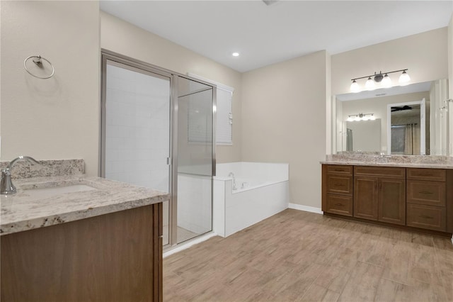 1564 Atlantic Coastline Loop, Oakland, FL 34787 - full bath with two vanities, a stall shower, a bath, and wood finished floors